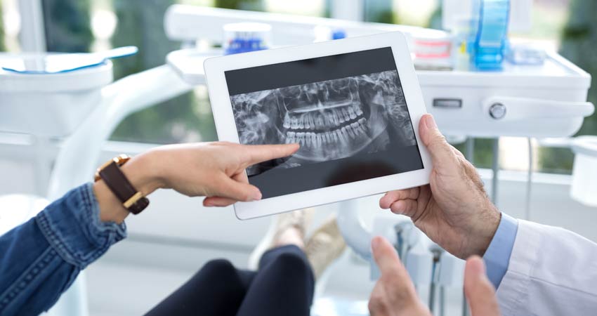 Dentist shows patient digital x-rays